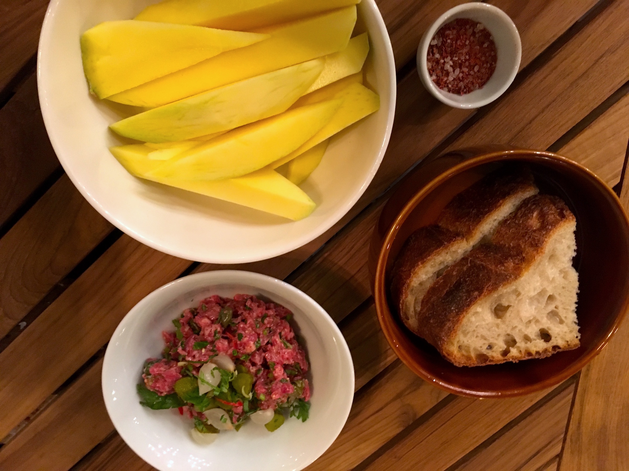 Mango with chili, Angus beef tartare with fresh bread at Beszálló