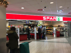 There is a Spar at the arrival level where you can buy some snacks for your flight (Budapest Airport)